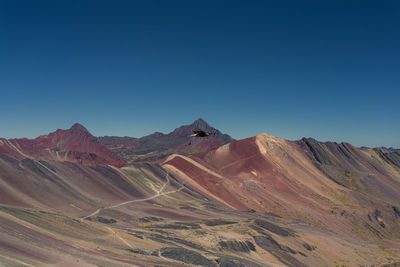 Scenic view of mountains against clear blue sky