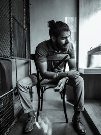 Young man sitting on chair at home