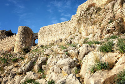 Low angle view of rock formations against sky