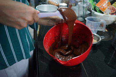 Midsection of person preparing food in kitchen