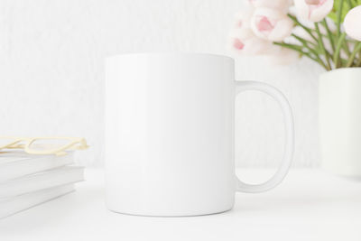 Close-up of white roses in vase on table