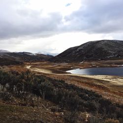 Scenic view of river and hill