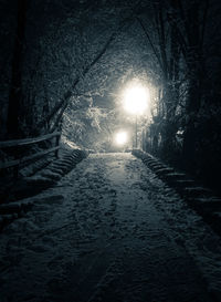 Illuminated tunnel at night