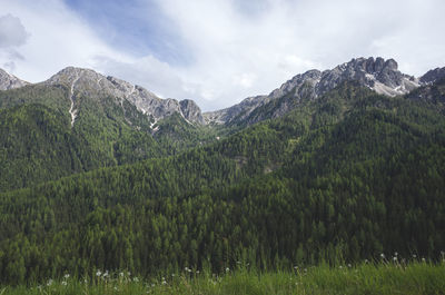 Scenic view of mountains against cloudy sky