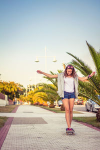 Full length of woman standing against clear sky