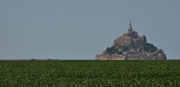 Church on field against clear sky