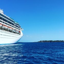 Cruise ship in sea against clear blue sky