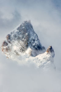 Person on mountain against sky