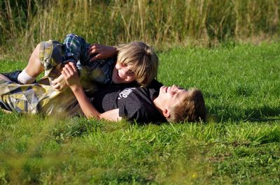 Portrait of man relaxing on grassy field