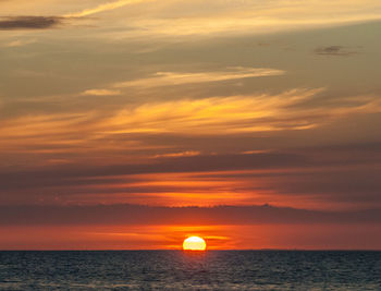 Scenic view of sea against orange sky at sunset