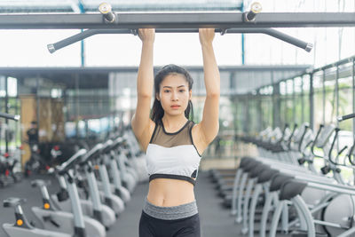 Portrait of confident woman exercising at gym