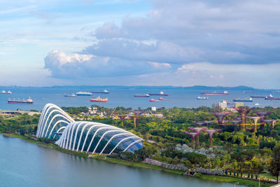 Scenic view of sea by city against sky