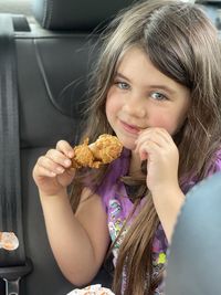 Portrait of girl eating food