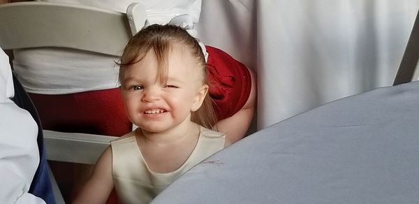 Portrait of cute smiling girl lying on bed