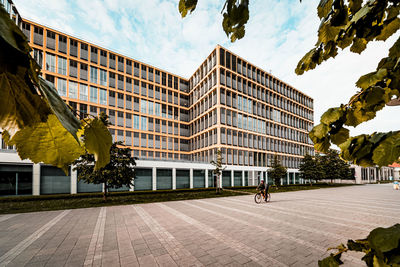 Street by buildings against sky