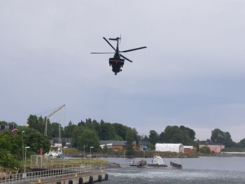 View of helicopter in city against sky