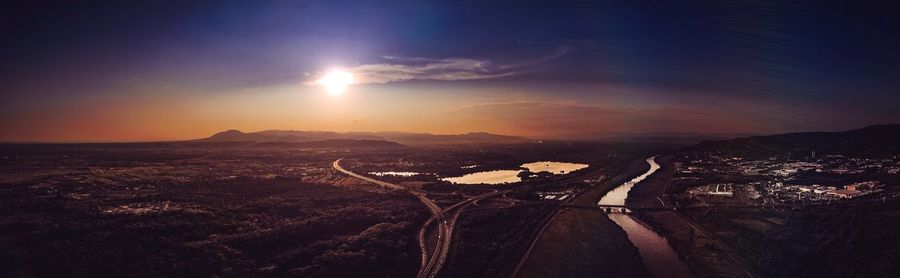 Aerial view of city against sky during sunset