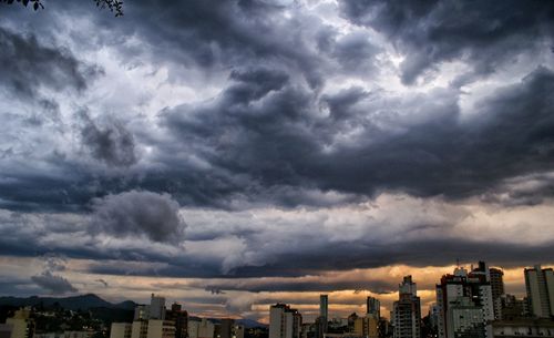 Buildings against cloudy sky