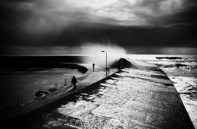 Scenic view of calm sea against cloudy sky