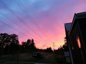 Low angle view of silhouette trees against sky