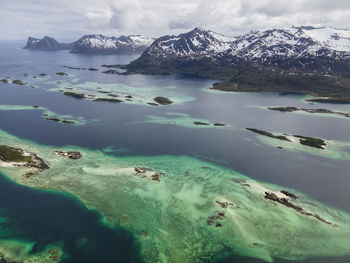 Scenic view of sea and mountains against sky