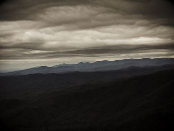 Scenic view of mountains against cloudy sky