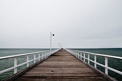 Pier over sea against sky