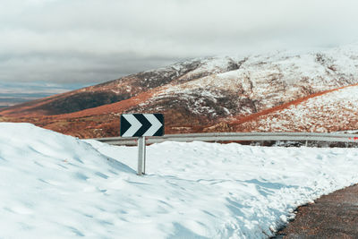 Snow covered land and mountains against sky