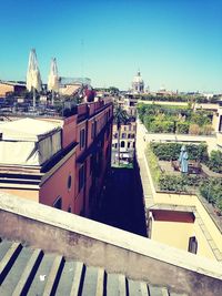 Buildings in city against blue sky