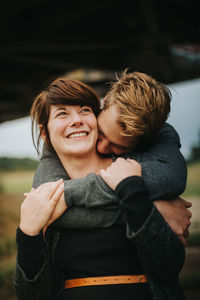 Smiling couple embracing in park