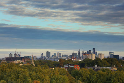 View of cityscape against cloudy sky