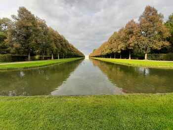 Scenic view of lake by trees against sky