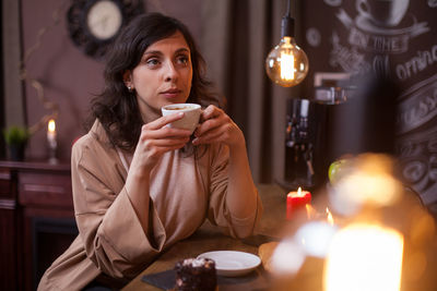 Portrait of young woman sitting in cafe