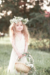 Portrait of cute girl wearing wreath at park
