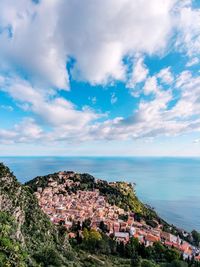 Townscape by sea against sky