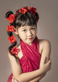 Portrait of a girl with red flower