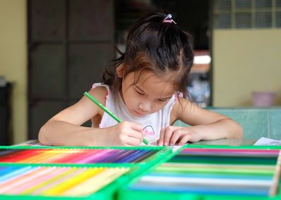 Cute girl sitting on table
