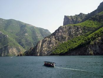 Scenic view of sea and mountains against clear sky