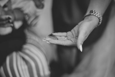 Midsection of woman holding fallen hair