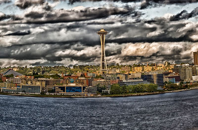 View of cityscape against cloudy sky