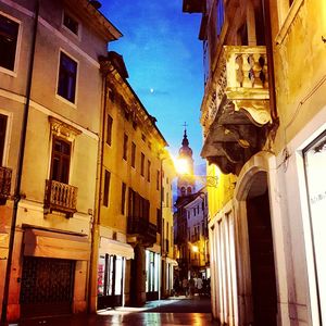 Narrow street in city at dusk