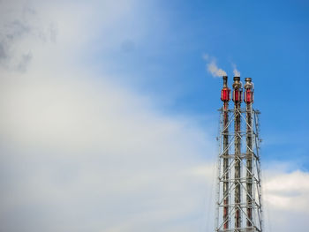 Low angle view of communications tower against sky
