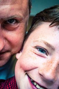 Close-up portrait of smiling boy with father 