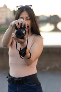 Portrait of photographer woman unfocused background at florence, italy. 50mm lens