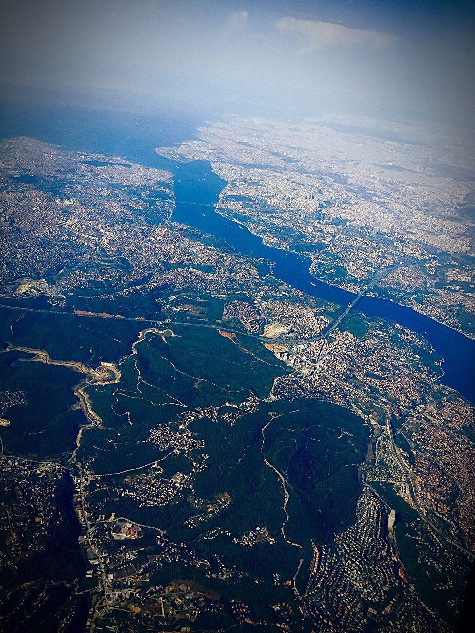 AERIAL VIEW OF SEA WITH CITYSCAPE IN BACKGROUND