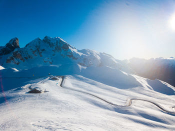 Scenic view of snowcapped mountains against clear blue sky