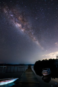 Scenic view of lake against sky at night