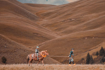 People riding horses on land