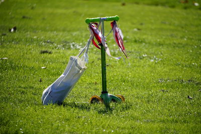 Low angle of a kid's scooter on field