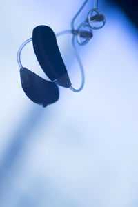 Low angle view of shoes against blue background